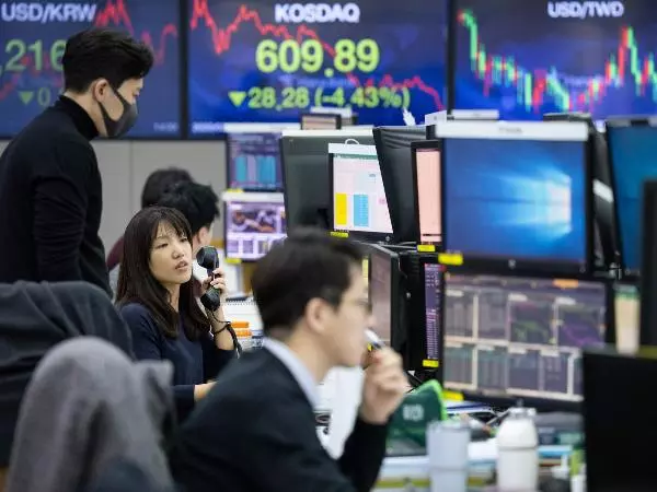 Minimalist trading desk setup showing forex charts on multiple screens